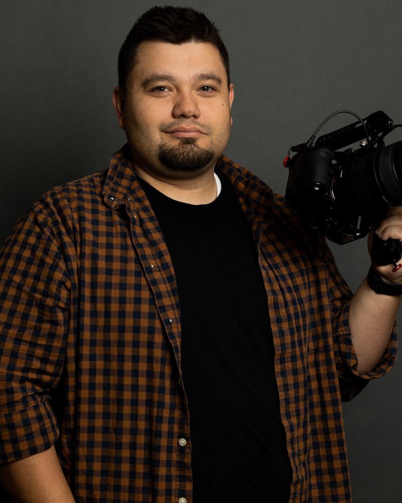 Danny Rubio holding a cinema camera against a dark backdrop