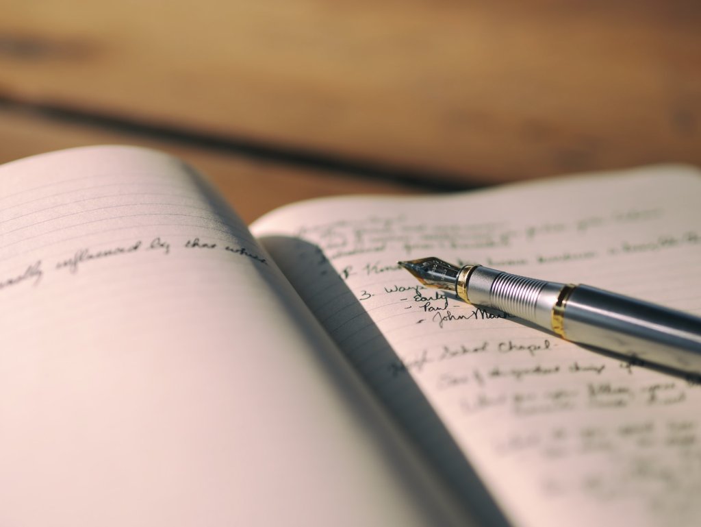pen on white lined paper selective focus photography.